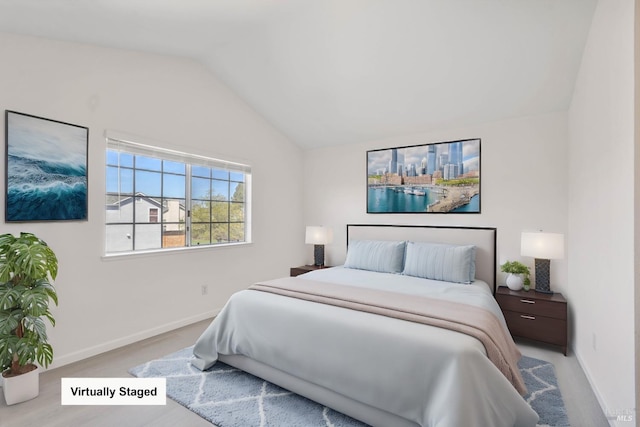 bedroom featuring baseboards and lofted ceiling