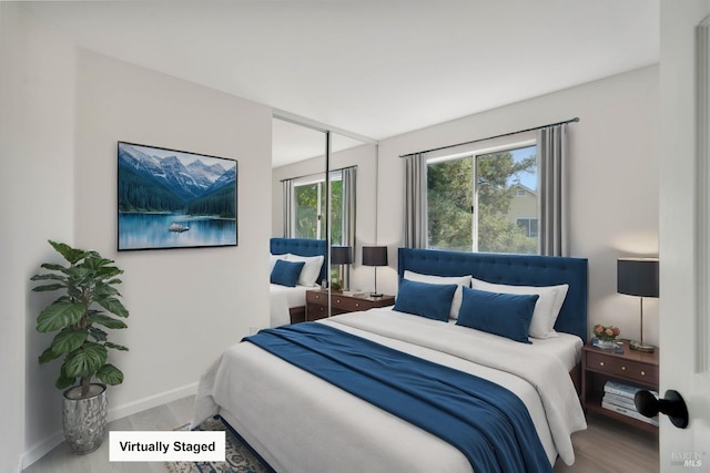 bedroom featuring baseboards and wood finished floors