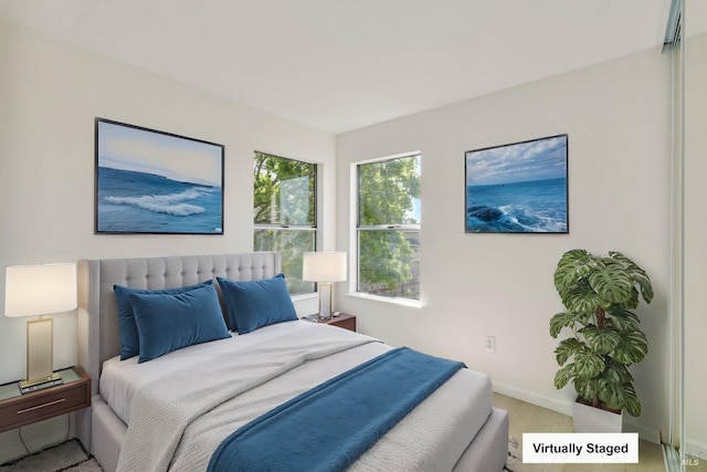 bedroom featuring baseboards and wood finished floors