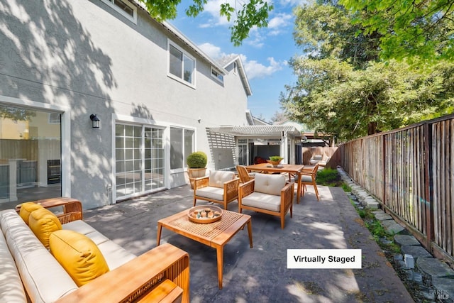 view of patio / terrace featuring a pergola, an outdoor living space, a fenced backyard, and outdoor dining space