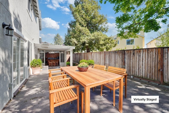 view of patio / terrace featuring a fenced backyard, a pergola, and outdoor dining space