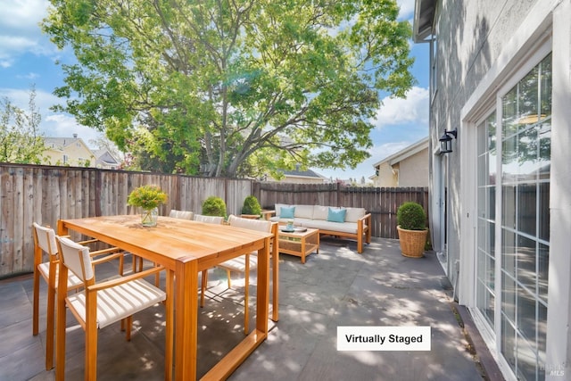 view of patio featuring an outdoor living space, outdoor dining area, and a fenced backyard