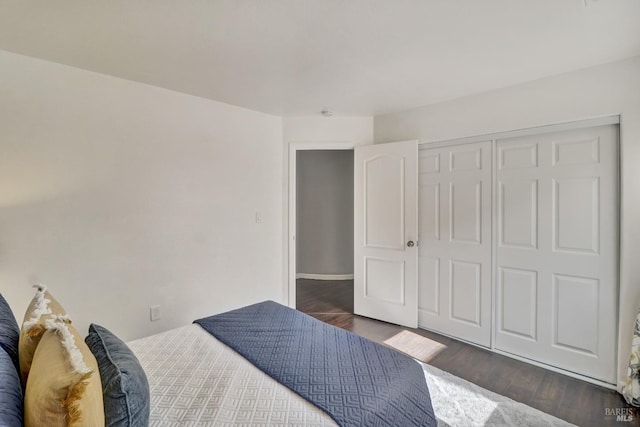 bedroom with a closet and dark wood-type flooring