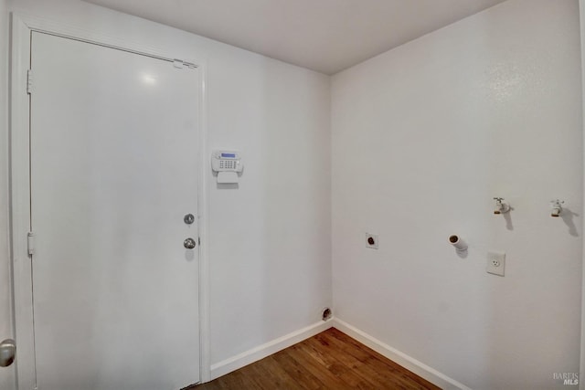 washroom with laundry area, electric dryer hookup, hookup for a gas dryer, dark wood finished floors, and baseboards