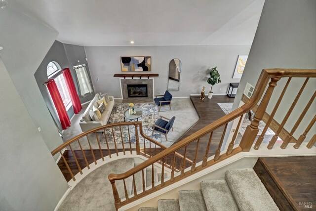 stairs with a tiled fireplace, baseboards, and recessed lighting