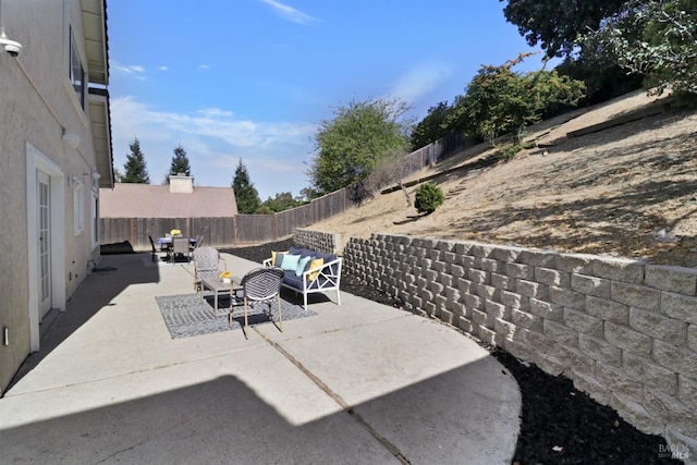 view of patio featuring an outdoor living space and a fenced backyard