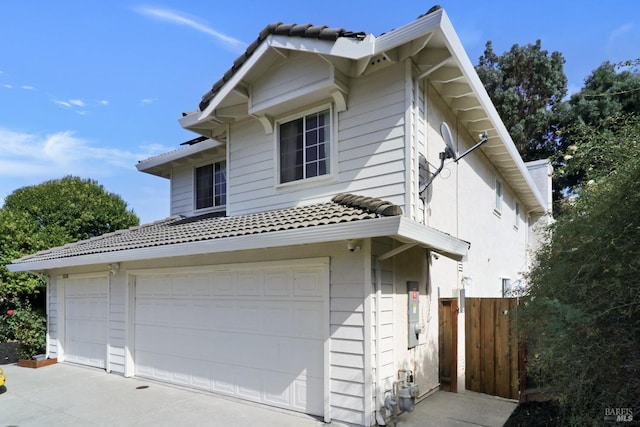 view of front of house with fence and a tiled roof
