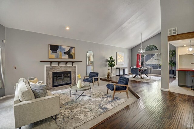 living room with visible vents, wood finished floors, a fireplace, baseboards, and recessed lighting