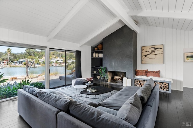 living area with a fireplace, wood walls, wood-type flooring, a water view, and vaulted ceiling with beams