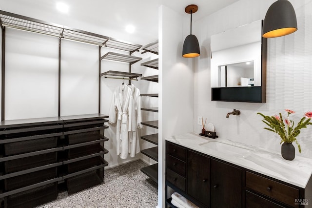 walk in closet featuring a sink