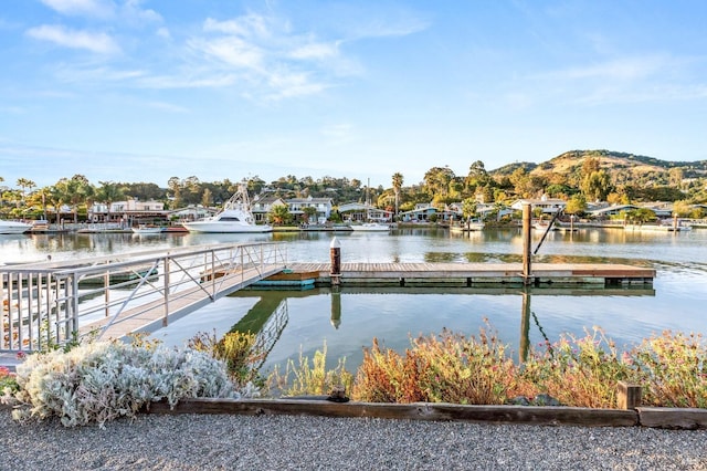 view of dock featuring a water and mountain view