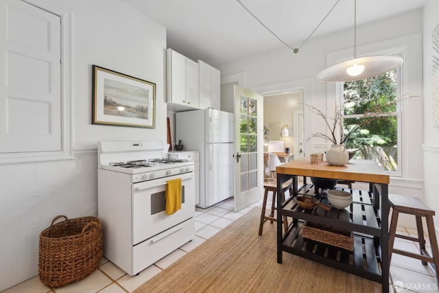 62 Walter St, San Francisco, CA 94114 - kitchen featuring light tile patterned floors, white cabinets, white appliances, and a wealth of natural light