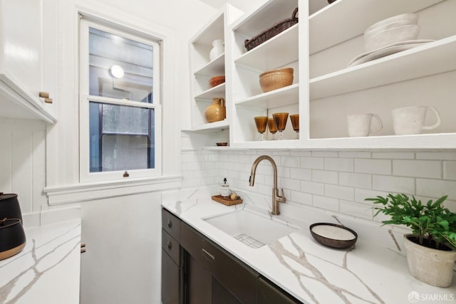 62 Walter St, San Francisco, CA 94114 - kitchen featuring tasteful backsplash, open shelves, a sink, light stone counters, and white cabinets