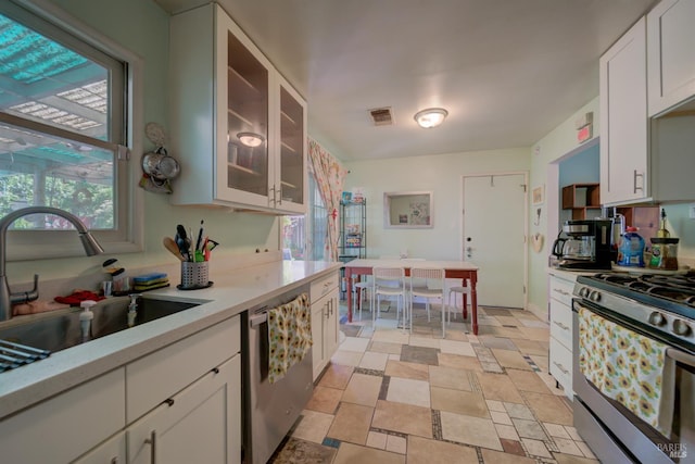 1812 Utah St, Fairfield, CA 94533 - kitchen with stainless steel appliances, light countertops, a sink, and white cabinetry