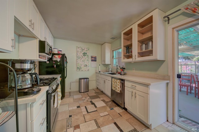 1812 Utah St, Fairfield, CA 94533 - kitchen with stainless steel appliances, light countertops, white cabinetry, and glass insert cabinets