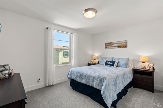 carpeted bedroom with baseboards