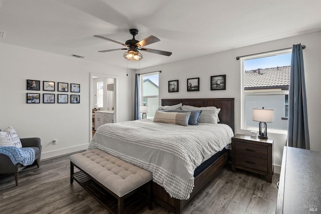 bedroom featuring dark wood-type flooring, baseboards, visible vents, and multiple windows