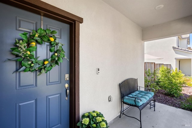 doorway to property featuring stucco siding