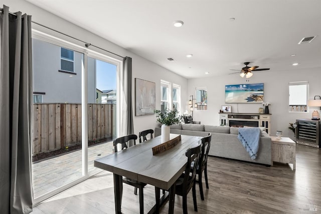 dining room featuring a ceiling fan, recessed lighting, beverage cooler, and visible vents