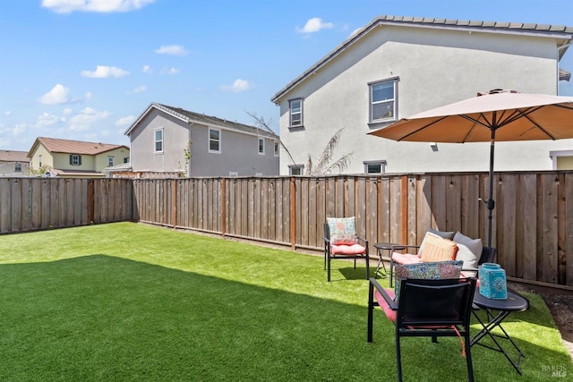 view of yard with a fenced backyard and a residential view