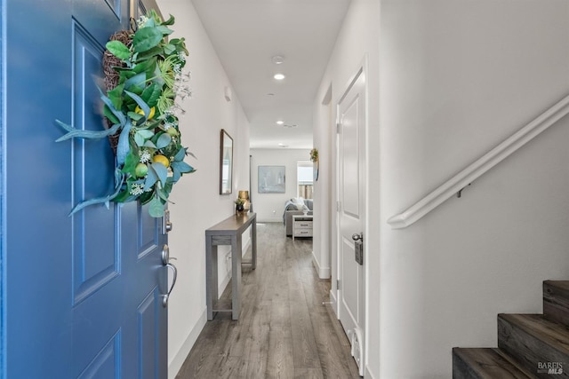 entryway with stairway, baseboards, recessed lighting, and wood finished floors
