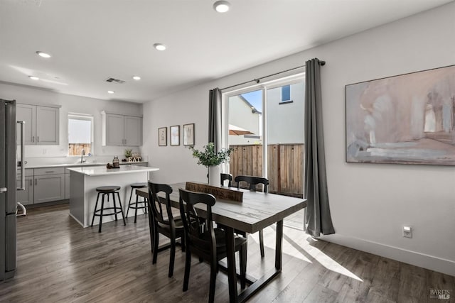 dining room featuring dark wood-type flooring, recessed lighting, baseboards, and visible vents