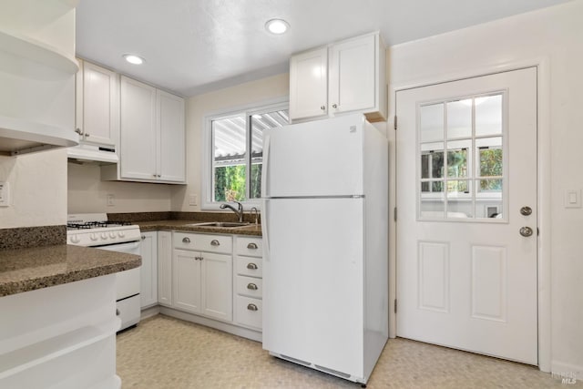 kitchen featuring a sink, under cabinet range hood, white cabinets, and white appliances