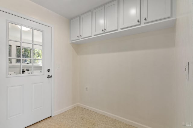 laundry area with baseboards