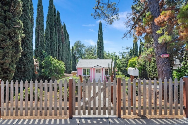 view of gate with an outdoor structure and fence private yard