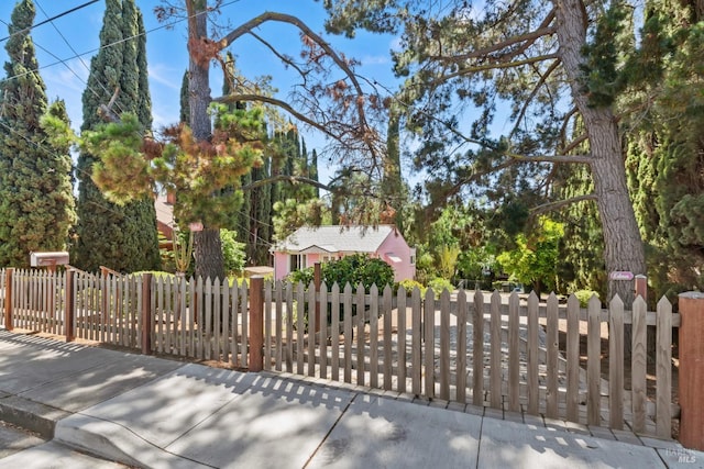 view of gate with a fenced front yard