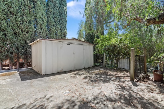 view of shed featuring fence