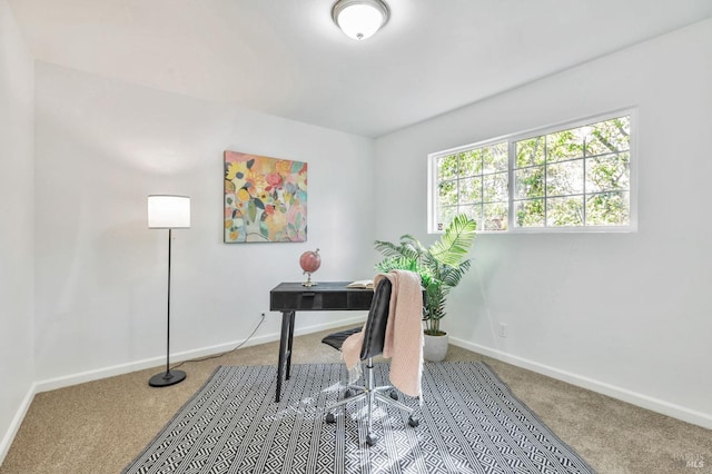 carpeted office space featuring baseboards