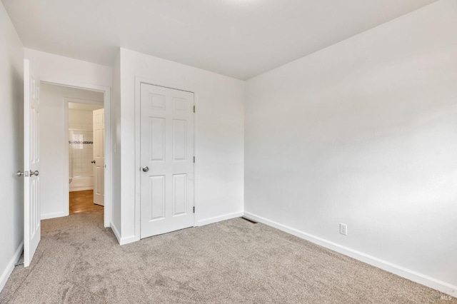 unfurnished bedroom featuring baseboards and carpet