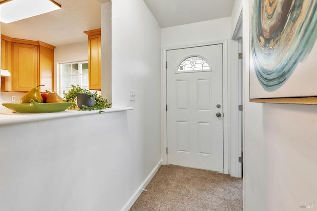 entryway featuring light colored carpet