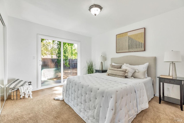 bedroom featuring light colored carpet and access to exterior