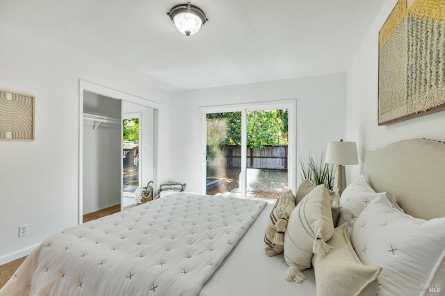 bedroom featuring baseboards, a closet, and access to exterior