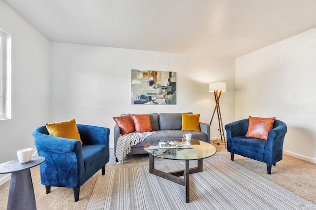 living room with baseboards and carpet