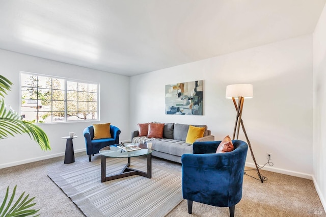 carpeted living room with baseboards