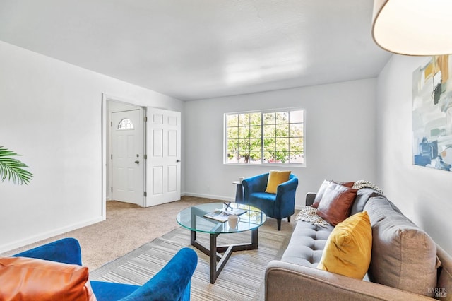 carpeted living room with baseboards