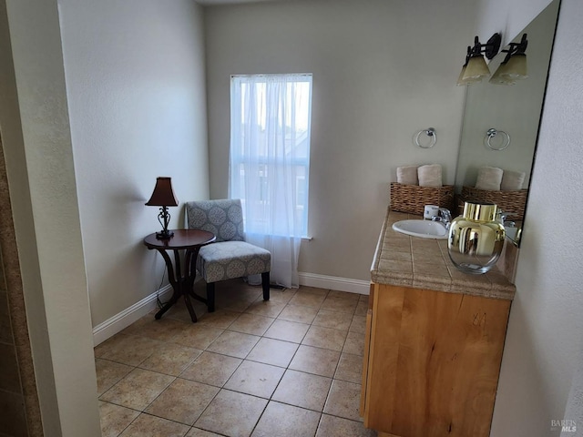 bathroom with baseboards, tile patterned flooring, and vanity