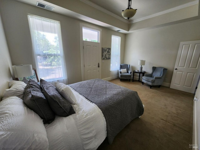 bedroom with visible vents, ornamental molding, baseboards, a raised ceiling, and carpet flooring