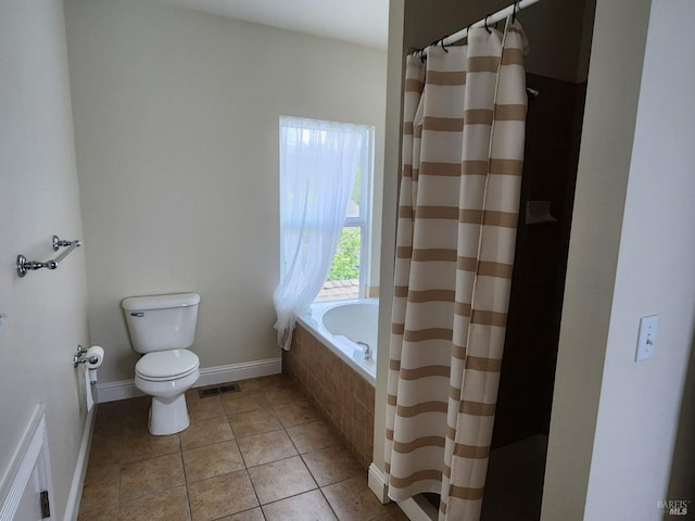 bathroom featuring a shower with curtain, visible vents, tile patterned flooring, baseboards, and toilet