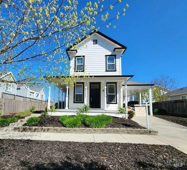 view of front of home featuring a porch, fence, driveway, and a carport
