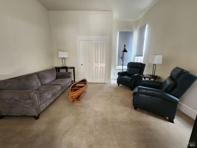 carpeted living room featuring baseboards