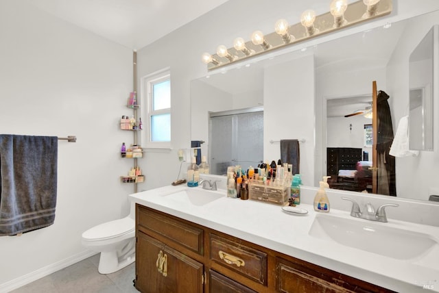 954 Coventry Ln, Fairfield, CA 94533 - bathroom with a stall shower, toilet, tile patterned flooring, double vanity, and baseboards
