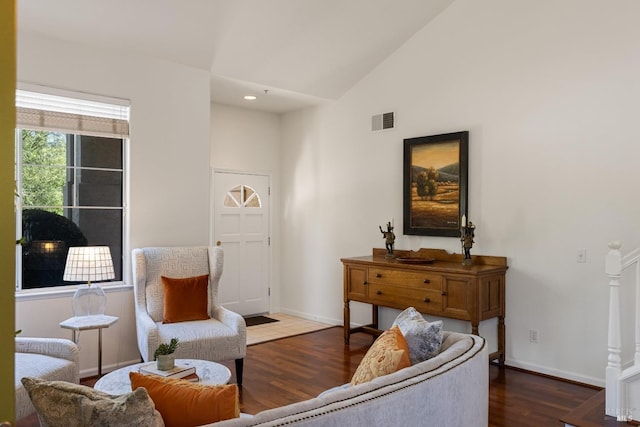 sitting room featuring baseboards, high vaulted ceiling, wood finished floors, and visible vents
