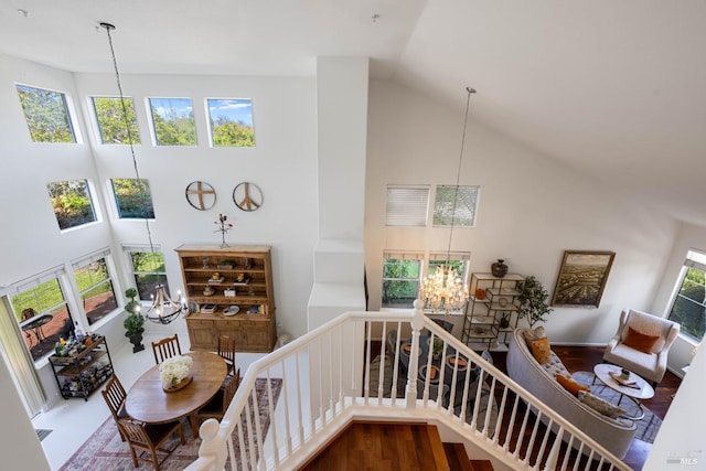 interior space with high vaulted ceiling and an inviting chandelier