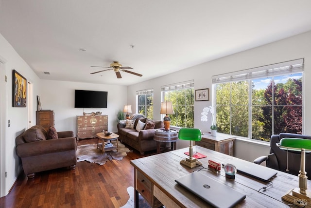 living area with ceiling fan, wood finished floors, and visible vents