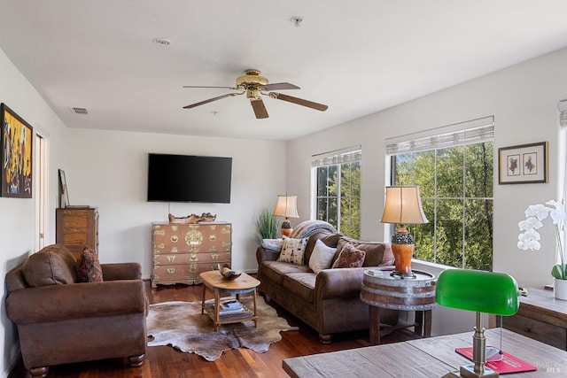 living room featuring ceiling fan, visible vents, and wood finished floors