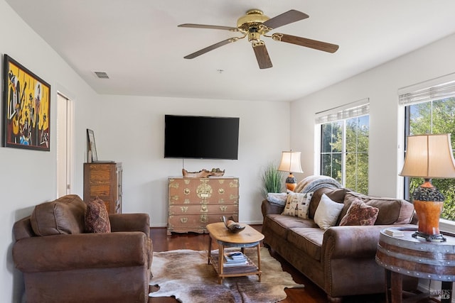 living room with visible vents, ceiling fan, and wood finished floors